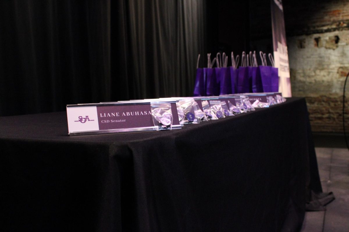 Nameplates on a table in the Jackie Liebergott Black Box theatre. (Riley Goldman/ Beacon Correspondent)