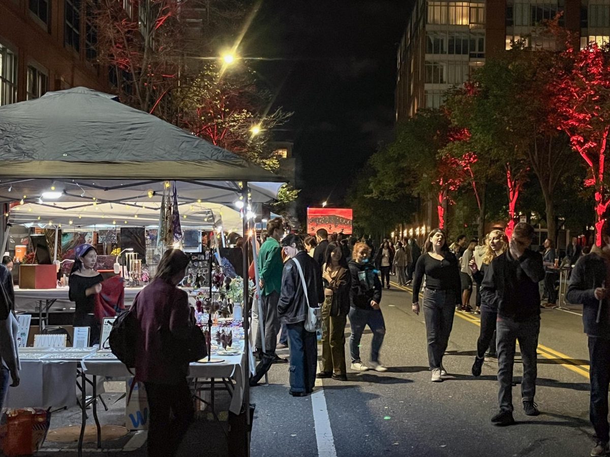 Shoppers peruse the stalls on Sidney Street at Central Square by Night on Saturday, Sept. 28, 2024. (Laith Hintzman/Beacon Correspondent)
