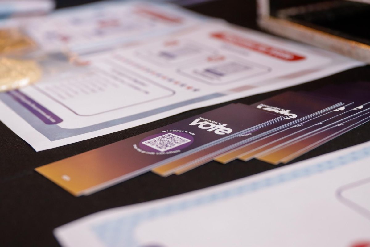 Voter registration materials and resources displayed on a table inside the Emerson College Dining Hall on Tuesday October 1, 2024. (Arthur Mansavage/ Beacon Staff)