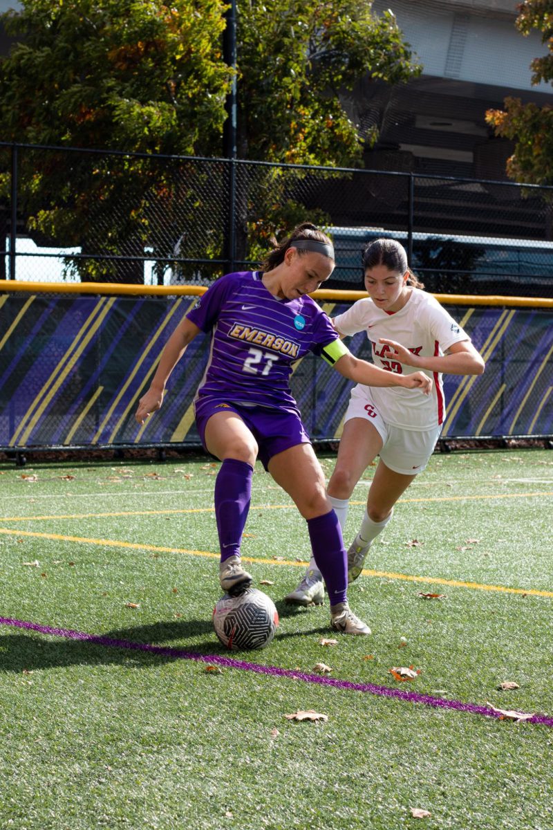 Senior midfielder Maddie Khaw controls the ball against a Clark defender. (Courtesy of Naia Driscoll)