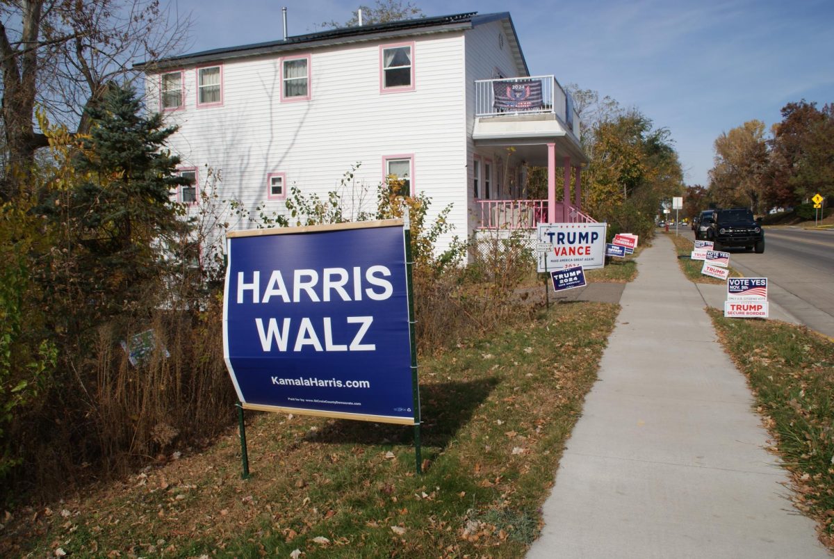 Neighboring homes in St. Croix County in Wisconsin with opposing political signs. (Hannah Brueske/ Beacon Staff)