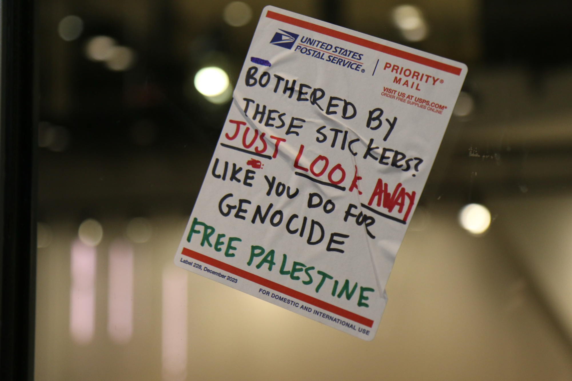 Dozens of pro-Palestinian protesters marched outside of the Israeli Consulate in Boston Tuesday before gathering in the Boylston Place Alleyway.