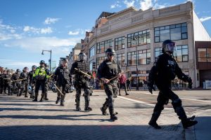 Boston Police officers in riot gear preparing to disperse protesters blocking and bringing the Men’s March to a halt. (Yogev Toby/ Beacon Staff)