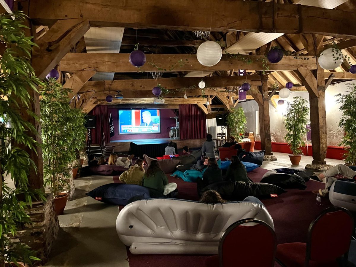 Students gather in the Kasteel Well barn for an Election Night watch party. (Iselin Bratz/Beacon Staff)