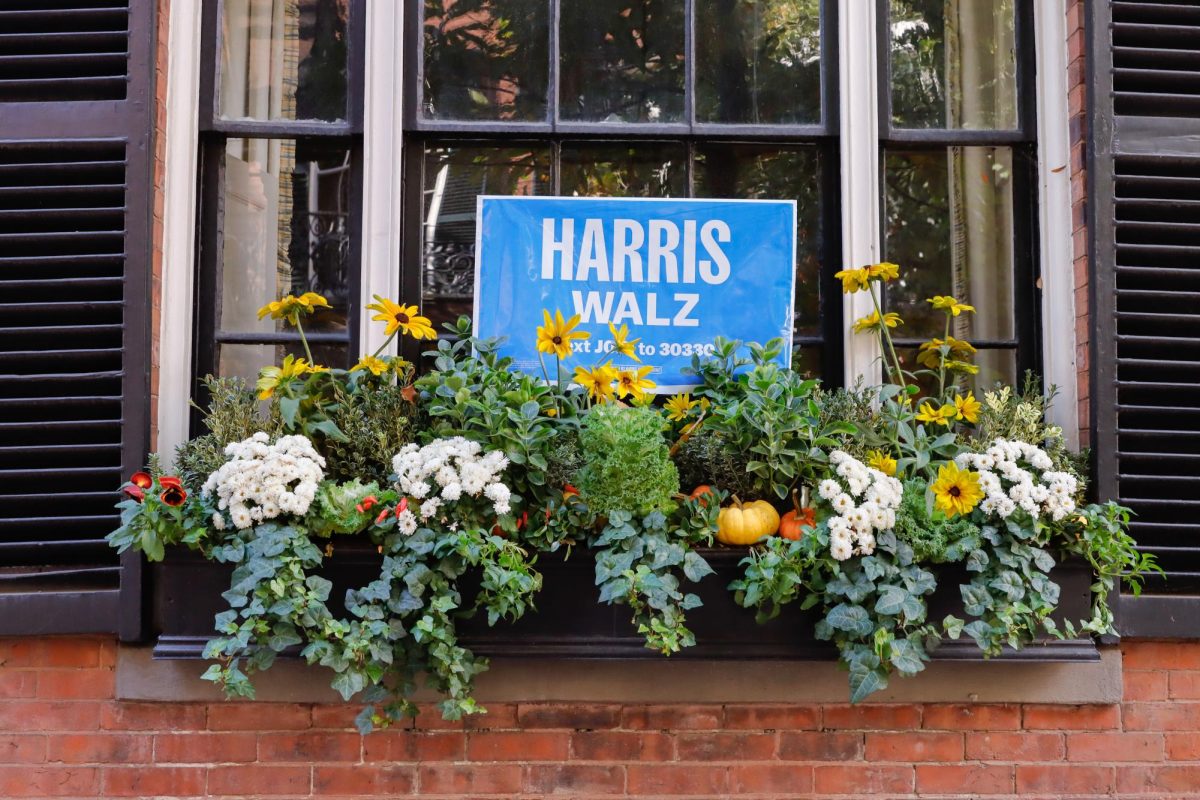 A Harris-Walz sign displayed in a window on Beacon Hill. (Arthur Mansavage/Beacon Staff).