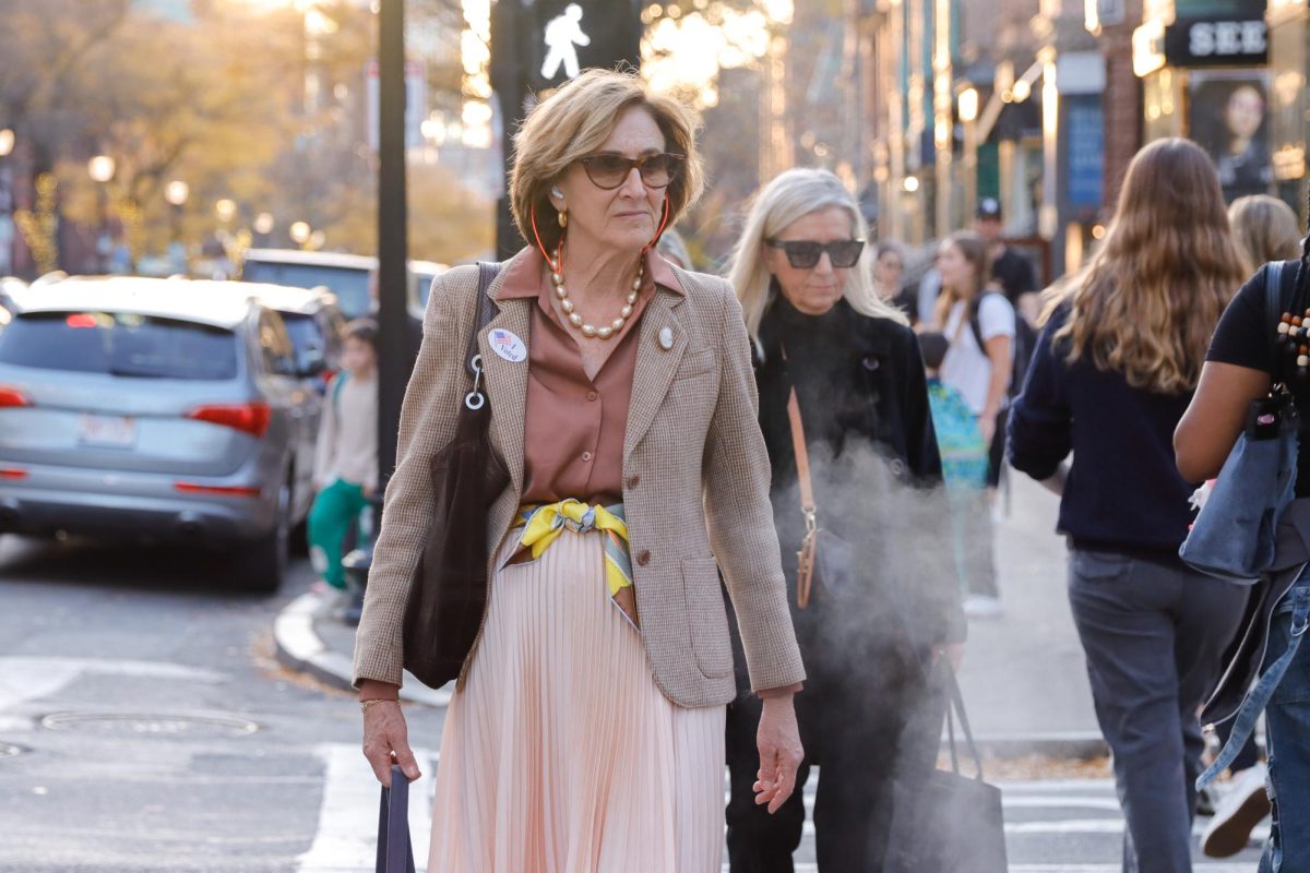 A person crosses the street in Back Bay wearing an “I voted” sticker on Tuesday, Nov. 5. (Arthur Mansavage/ Beacon Staff) 