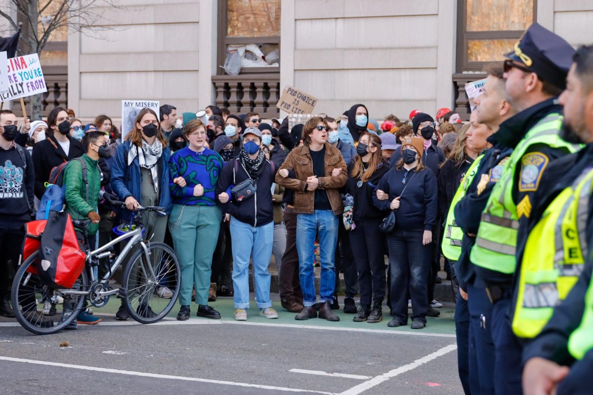 Hundreds of counterprotestors lock arms creating a blockade not allowing the Men's March to walk to their planned rally event in the the Boston Commons. (Arthur Mansavage/ Beacon Staff)