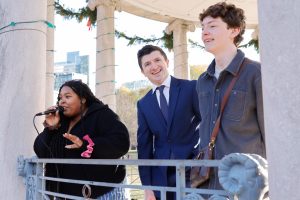 Contest organizer Dilce Elisa (left) stands with the two finalist Nick Anderson (center), and Michael Carroll (right) during the final round of voting. Anderson took home first and won $50 and a bag of British candy. (Arthur Mansavage/ Beacon Staff)