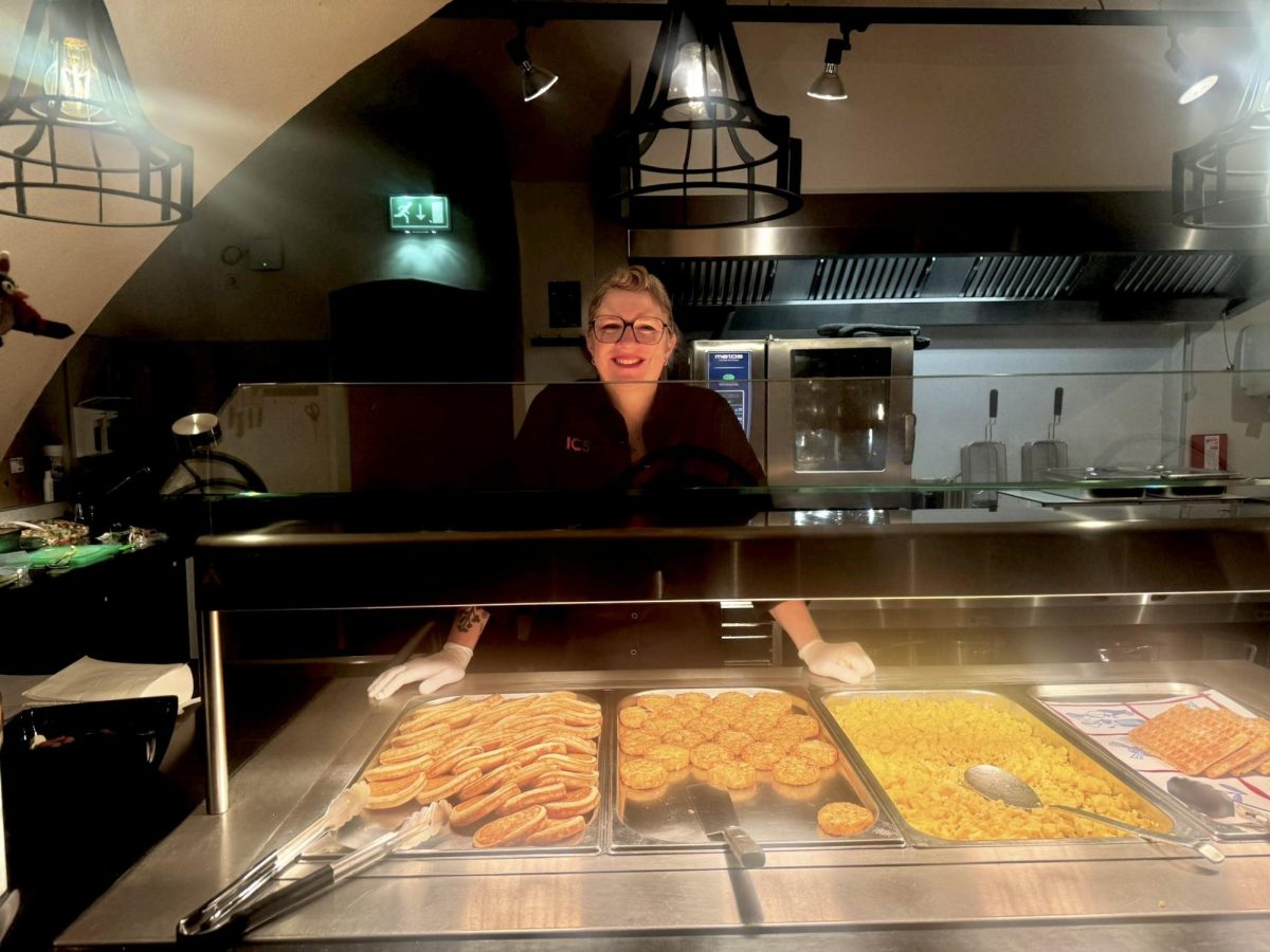 Melanea Vemealssel, a member of the Kasteel Well dining staff, stands by some of the breakfast offerings on Nov. 27, 2024 (Kaitlyn Smitten/Beacon Staff).