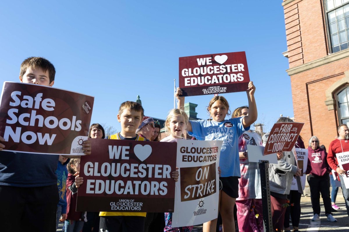 A group of children hold signs in support of the teachers at West Parish Elementary School on strike outside of Gloucester City Hall. (Rian Nelson/Beacon Staff)