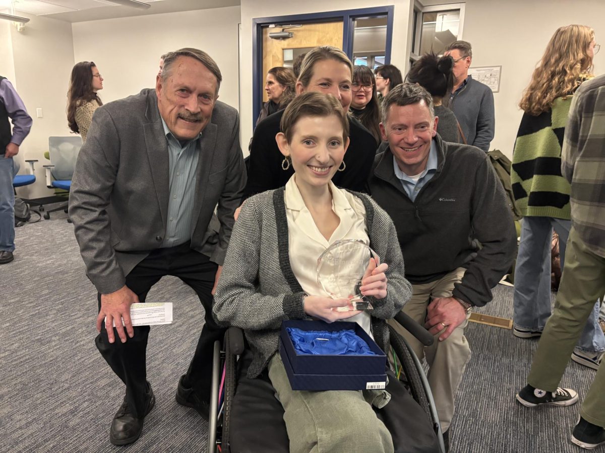 Nora Onanian receiving her award, "Courage, Grit, and Determination in Successful Journalism Degree Completion" on December 16, 2024. Left to right: Douglas Struck, Christine Onanian, David Onanian, Nora Onanian (front). 