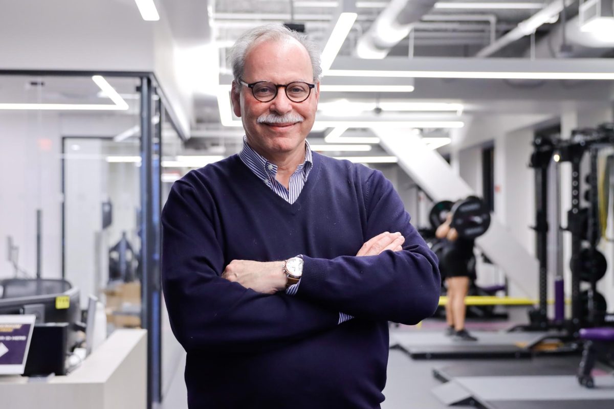 Paul Dworkis poses for a photo inside of the newly completed fitness center on Wednesday, Dec. 11, 2024. (Arthur Mansavage/ Beacon Staff)