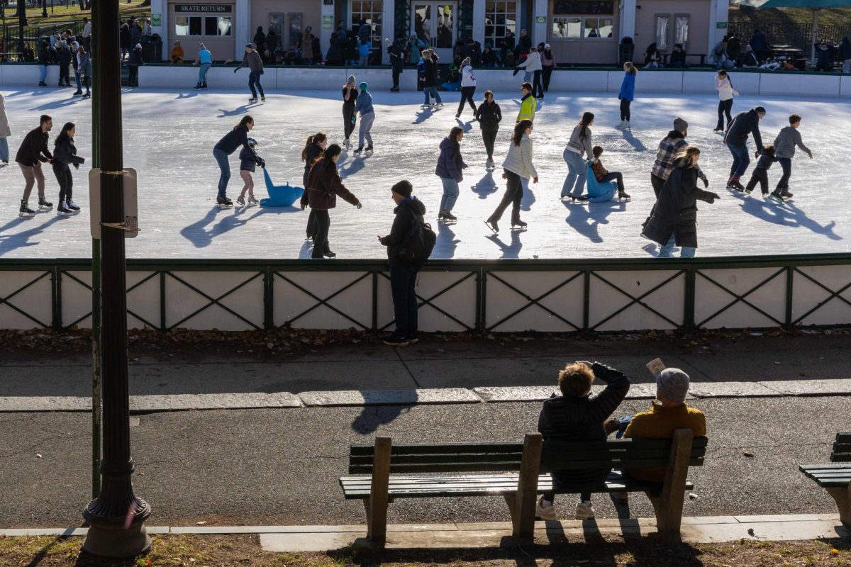 Visitors watching skaters at the Frog Pond in the Boston Commons on Sunday, Dec. 8, 2024. (Rian Nelson/ Beacon Staff)