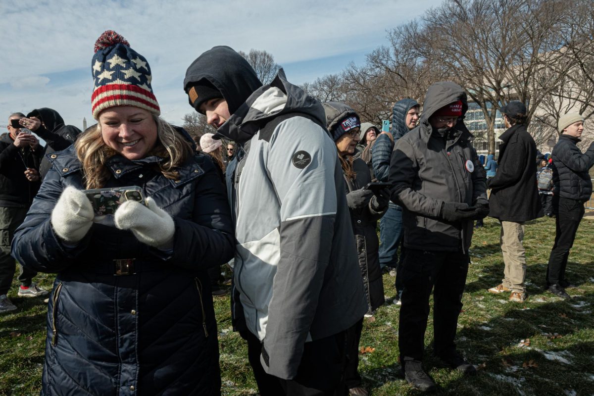 Trump supporters watching the inauguration live stream outside of the U.S. Capitol on Monday, Jan. 20, 2025. (Nick Peace/Beacon Staff)