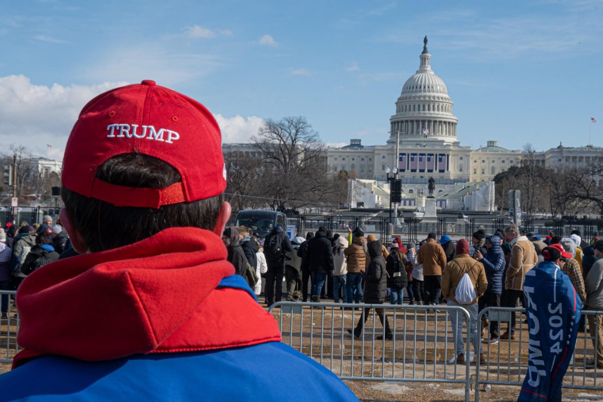 A Trump supporter wearing a MAGA hat looks toward the U.S. Capitol building as Trump is sworn in for a second term. (Nick Peace for The Beacon)