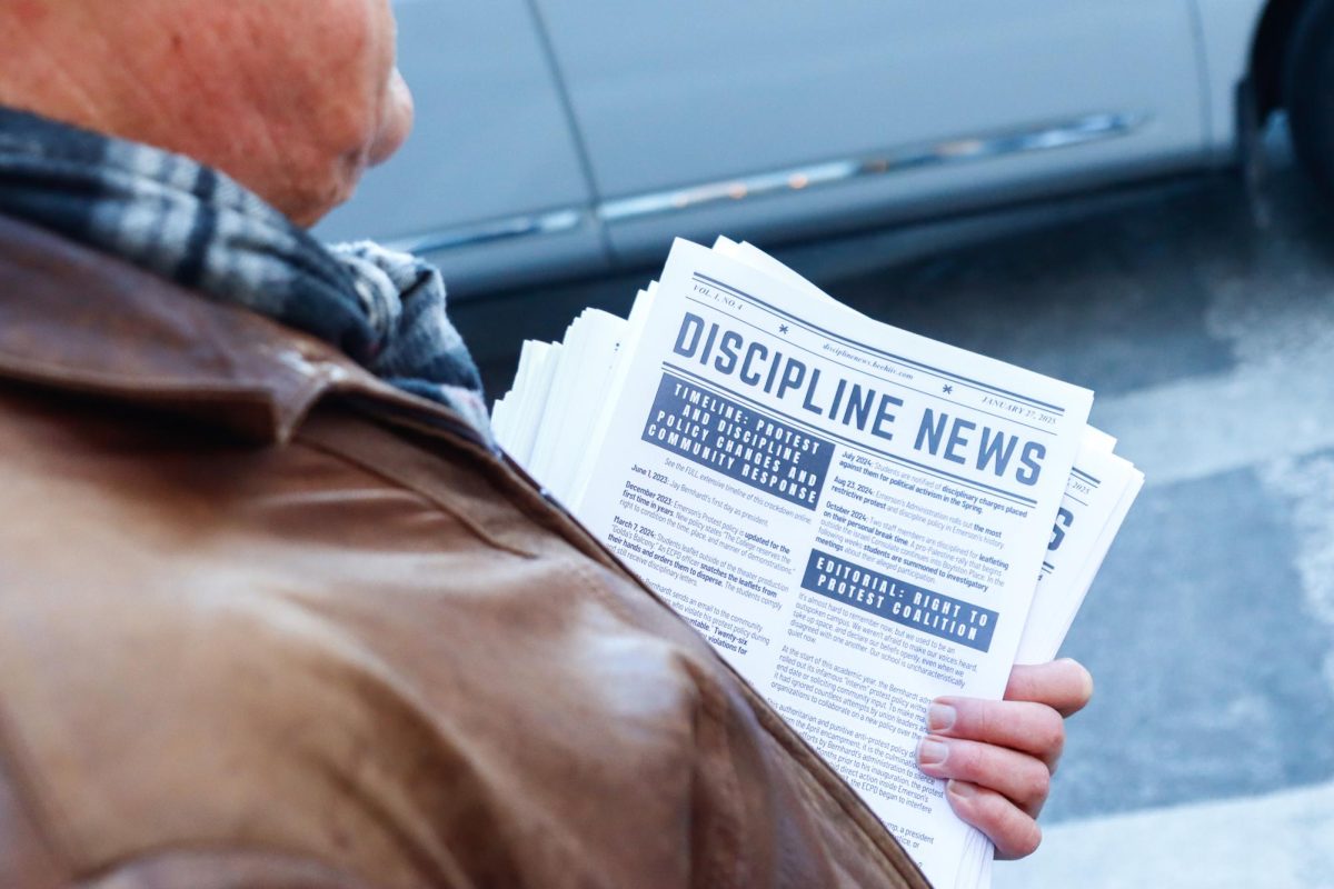 Doug Struck holds the latest issue of Discipline News on Boylston Street outside of Emerson College on Monday, Jan. 27, 2024. (Arthur Mansavage/ Beacon Staff)