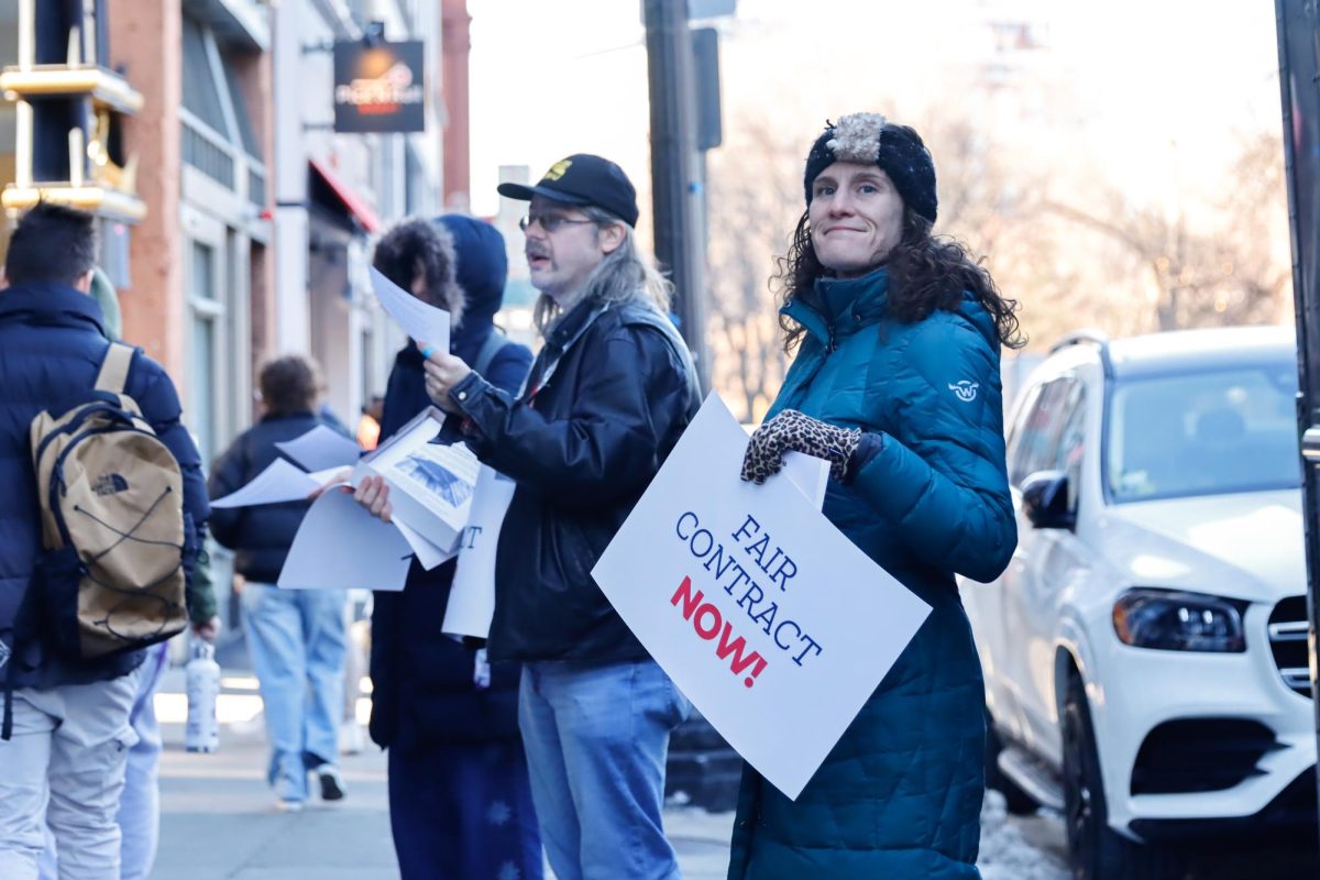 Dan Crocker and Amy Rinaldo leaflet on Boylston Street outside of the Emerson College Dining Hall on Thursday, Jan. 30, 2024. Crocker and Rinaldo are both leaders in the Emerson College Staff Union. (Arthur Mansavage/ Beacon Staff) 