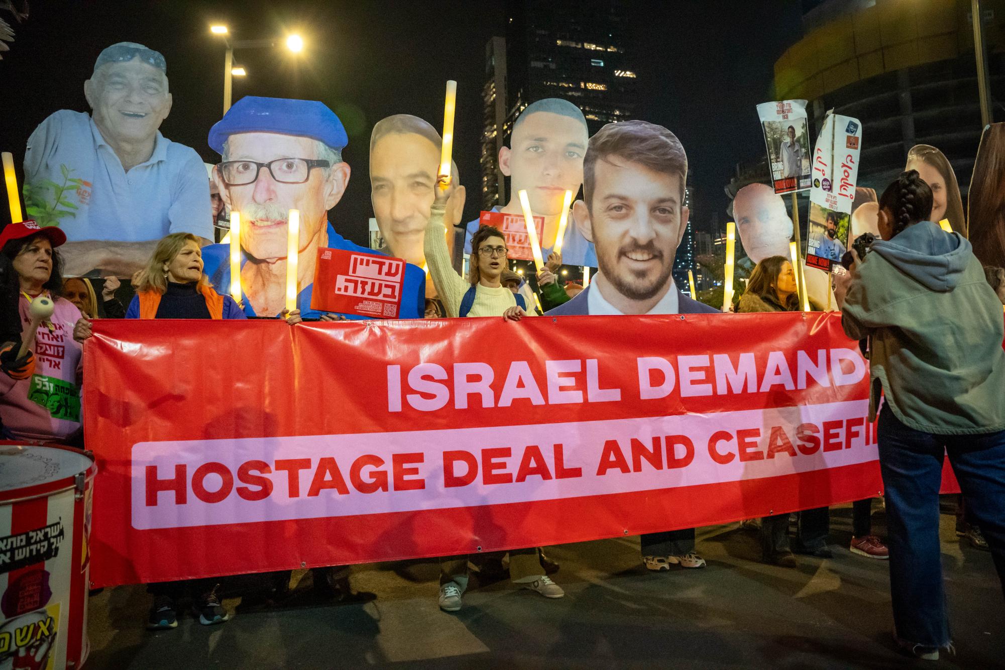 Families of hostages held by Hamas hold a banner calling for a ceasefire on Jan. 4, 2025. (Yogev Toby/ Beacon Staff)

