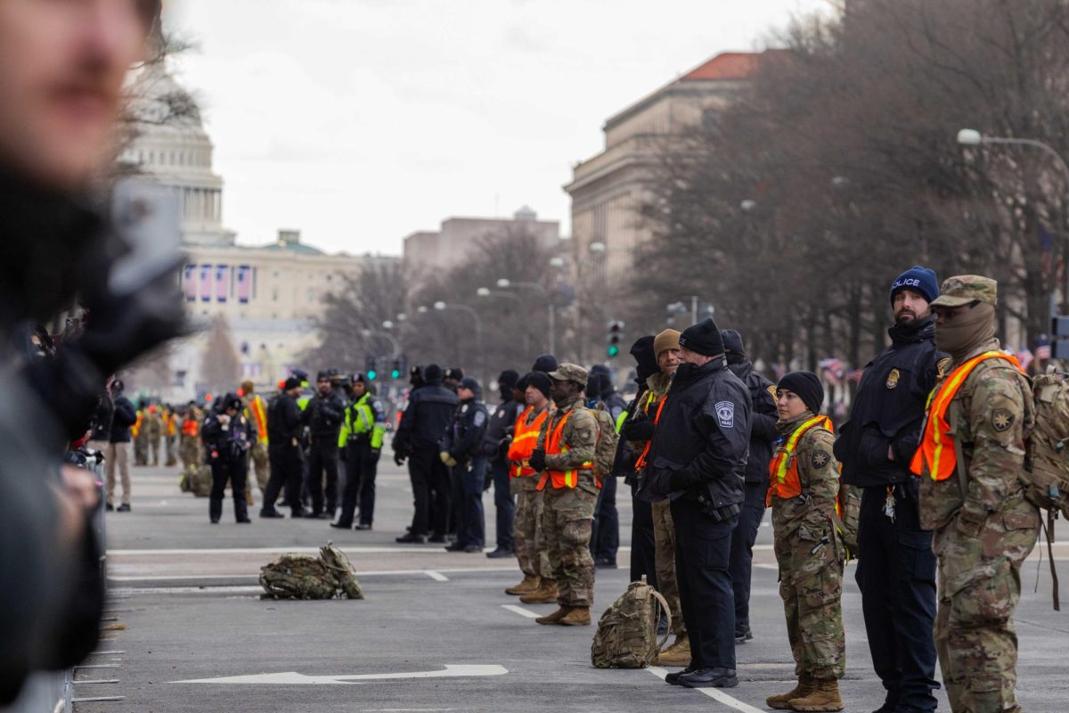 Law enforcement officials stand outside the U.S. Capitol Building after the ceremony was moved indoors due to historically cold temperatures. (Rian Nelson/Beacon Staff) 