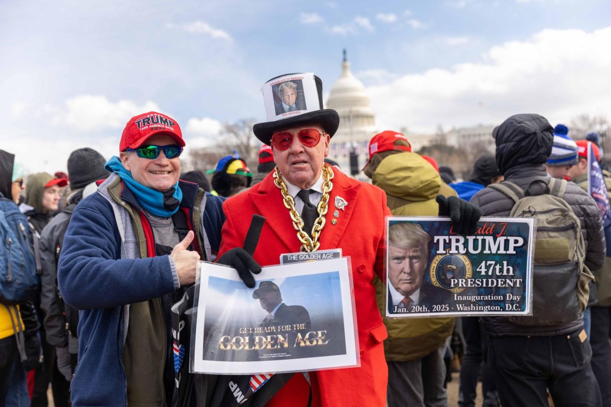 A crowd of roughly one thousand people stood outside the Capitol inauguration morning, echoing the president’s sentiments about a coming “golden age of America.” (Rian Nelson/Beacon Staff)