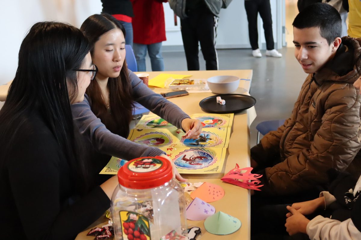 Attendees playing Bầu Cua Cá Cọp, a traditional Vietnamese dice game at Pao Arts Center. (Marley Noiwan/ Beacon Correspondent)