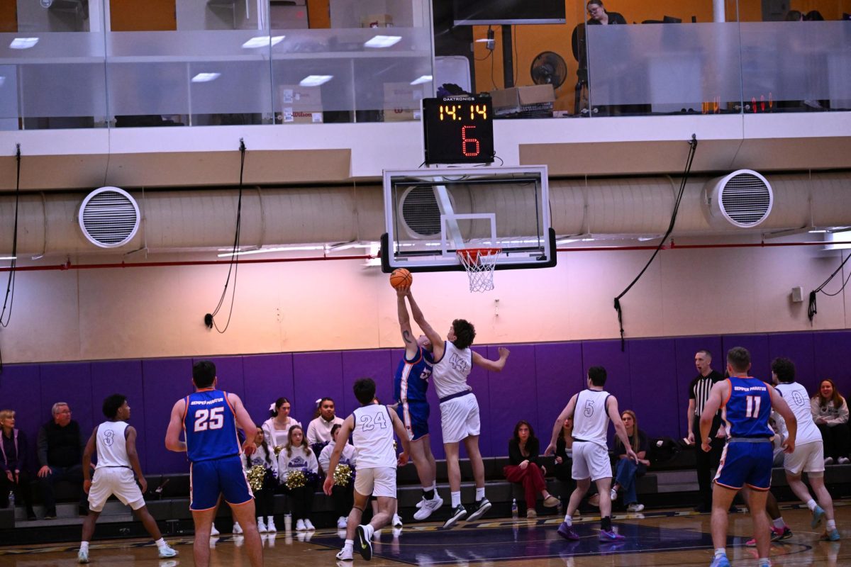 Junior center Linus Helmhold blocks a layup attempt against Coast Guard Academy on Jan. 29, 2025 (Riley Goldman/ Beacon Staff).