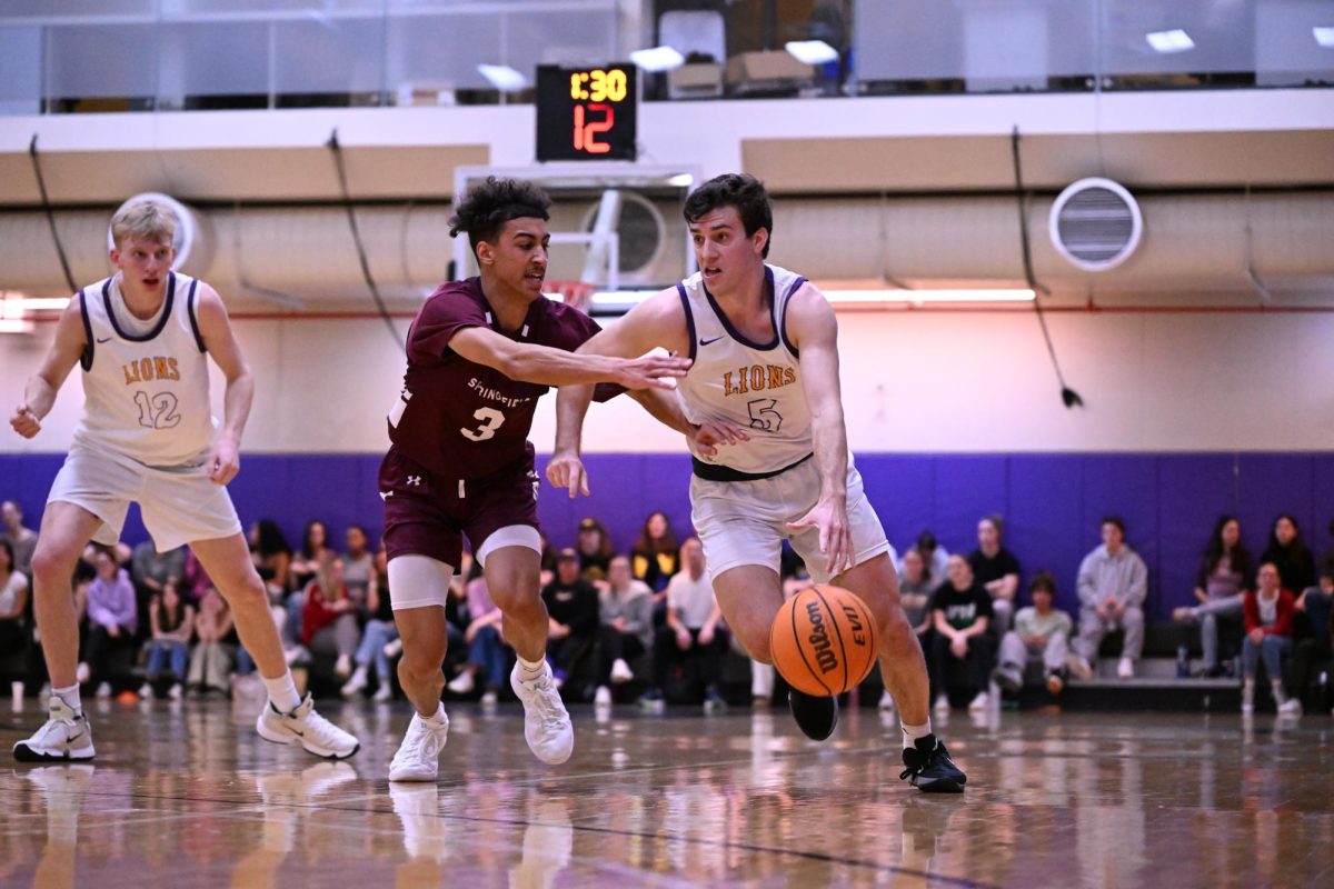 Graduate guard Trevor Arico drives against the Springfield College Pride on Feb. 25, 2025 (Riley Goldman/ Beacon Staff).