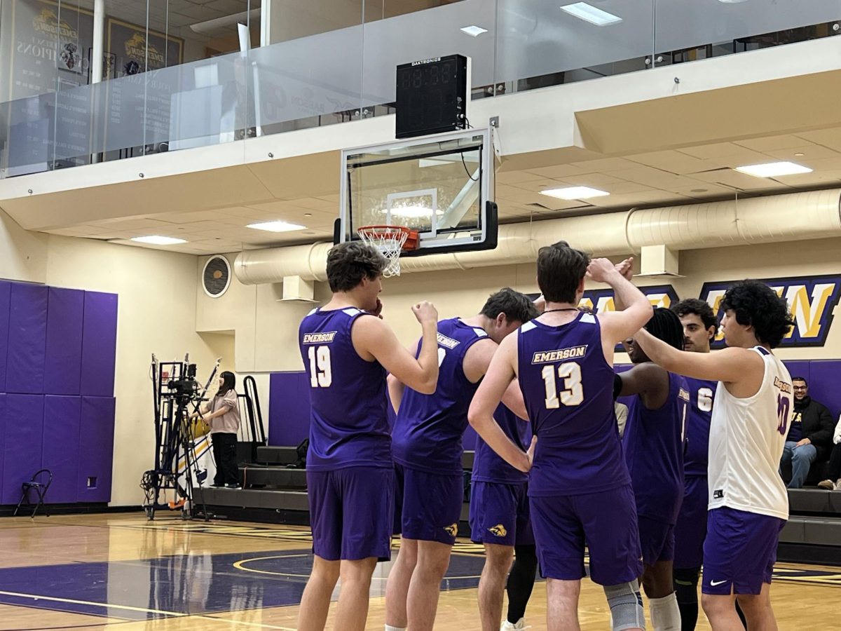 The Emerson men's volleyball team in a huddle prior to facing Fisher College on Feb. 20, 2025 (Jordan Pagkalinawan/ Beacon Staff).