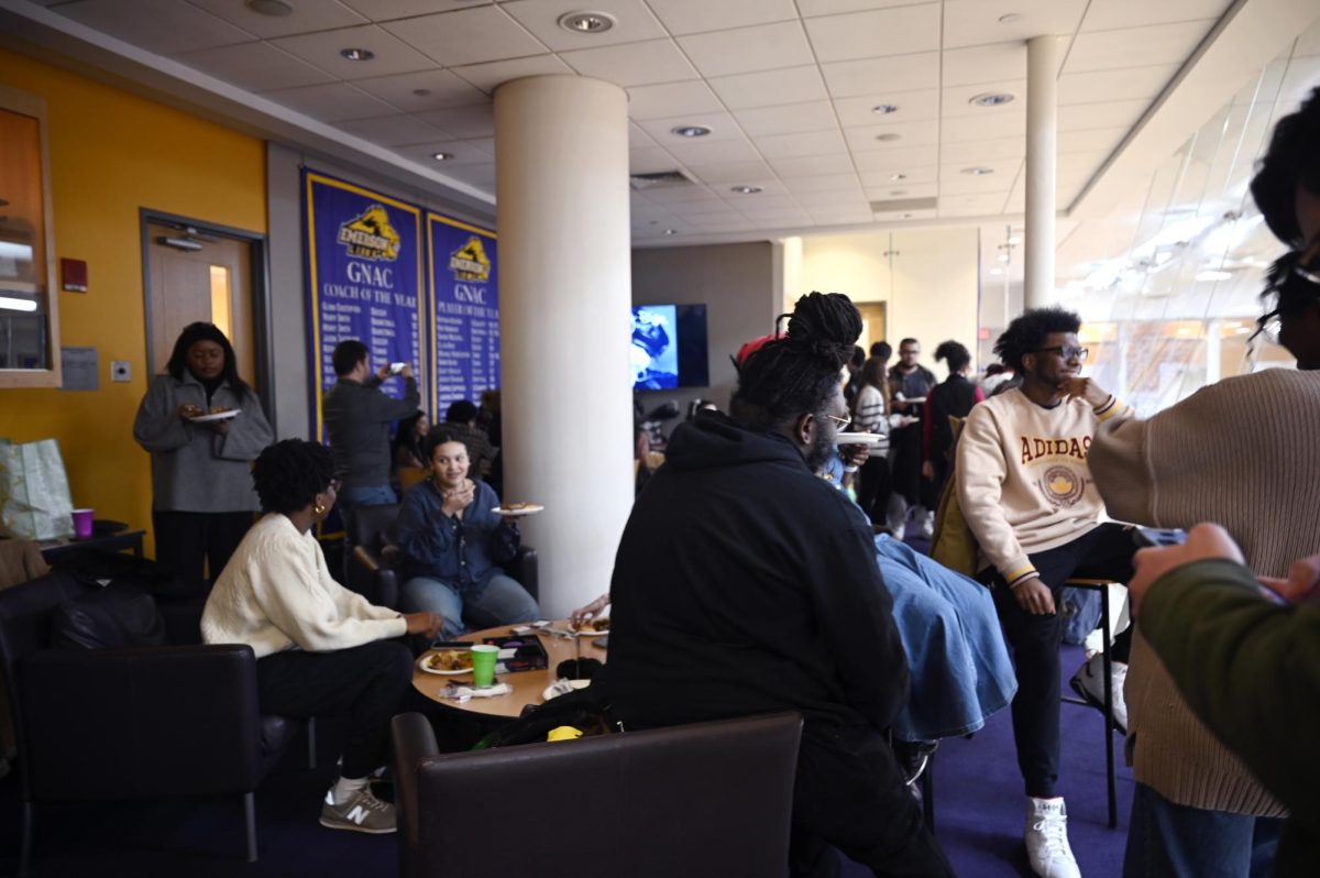 Students gather in sky box sharing food and conversation (Izzy Bryars/ Beacon Staff).