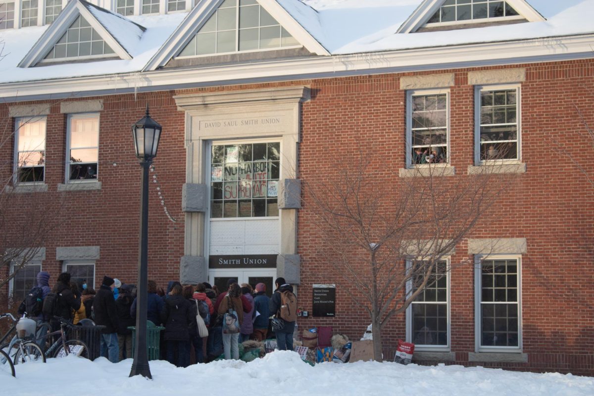 Protestors outside of the Smith Union as protestors chant and hold signs during the Bowdoin Encampment. (Janet Briggs/ The Bowdoin Orient)