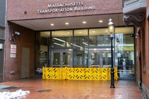 Yellow caution barriers block the entrance to the Massachusetts Transportation Building in the 2 Boylston Place alley on Thursday Feb. 13, 2025. ECPD sent a community advisory telling students and staff to stay away from the area. (Arthur Mansavage/ Beacon Staff)