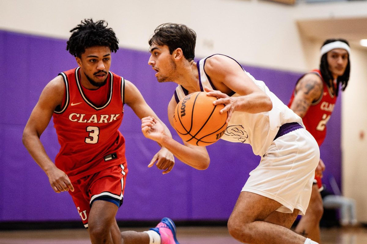 Men's basketball forward Guillermo Gasset-Ruiz drives against a Clark defender on Feb. 8, 2025 (Courtesy of Nate Gardner).