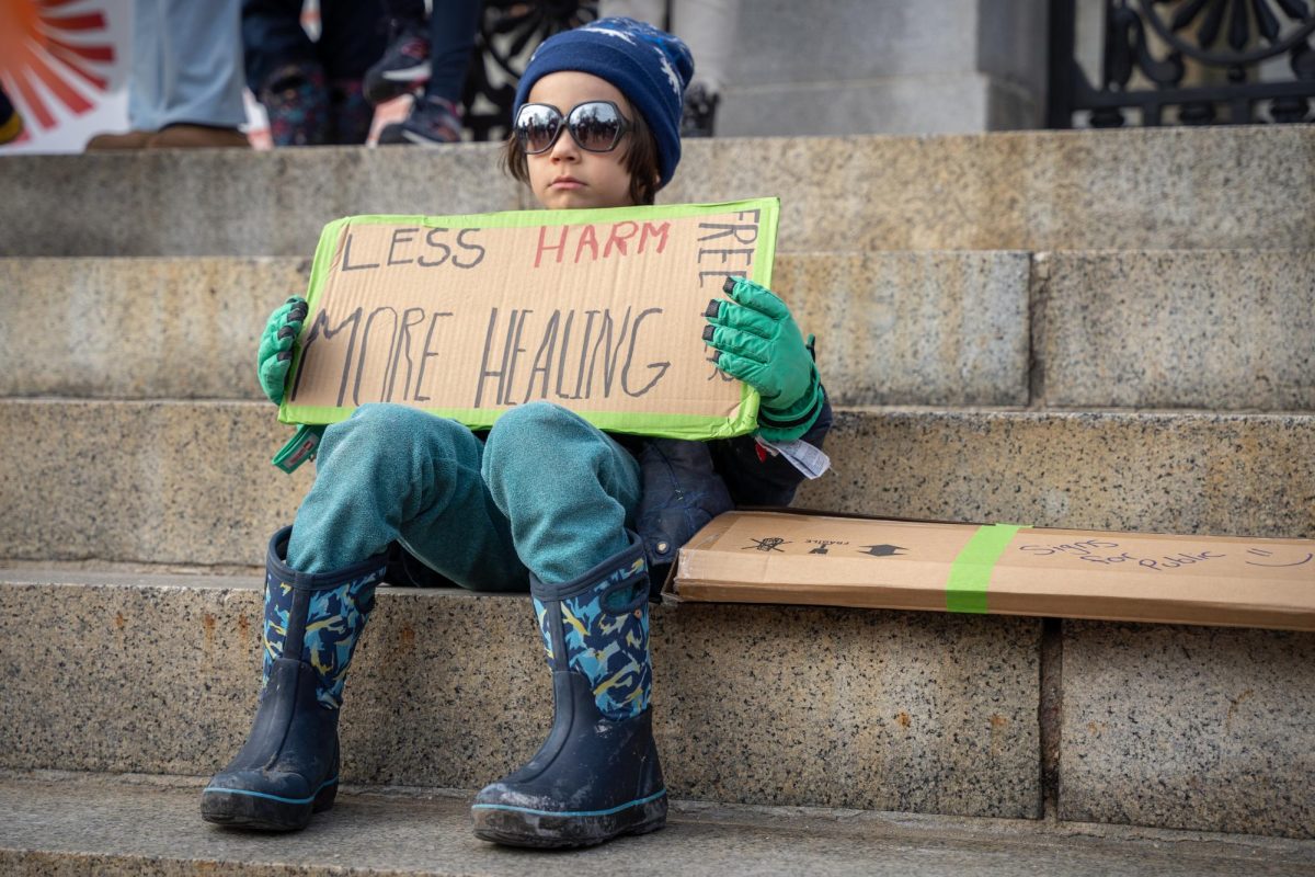 A student with the Boston Workers Circle fifth graders class holds a sign in support of prison reform on Feb. 23 (Yogev Toby / Beacon Staff)