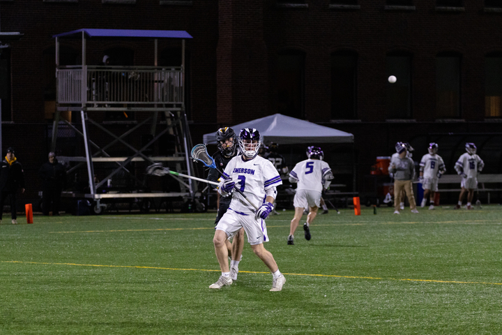 Peirce Eldredge playing for the Emerson men's lacrosse team (Arthur Mansavage/ Beacon File).