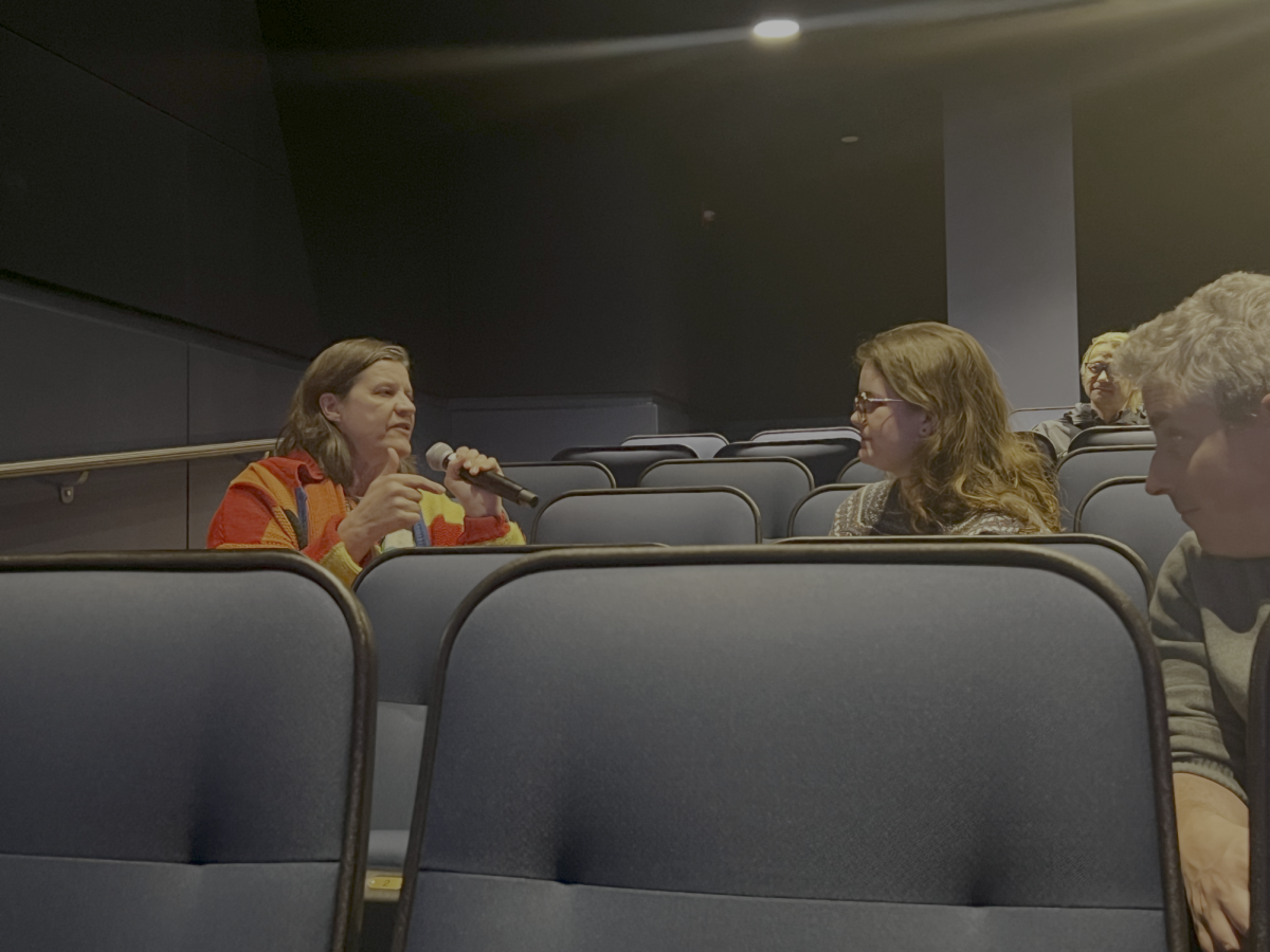 Kirsten Johnson sits next to an audience member during a post-screening Q&A of "Dick Johnson is Dead." (Fiona McMahon / Beacon Staff)