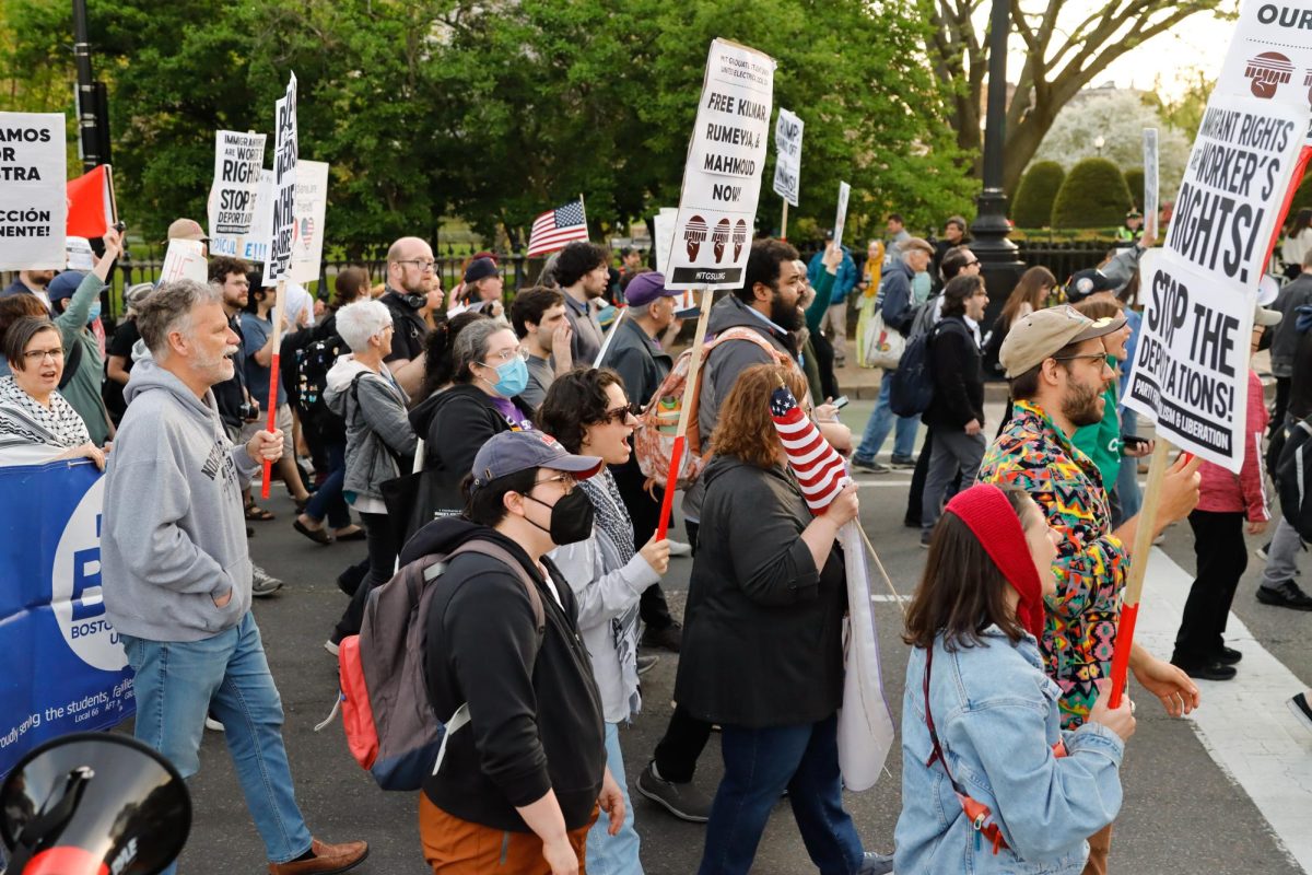 May Day rally goers marching on a street in Downtown Boston on Thursday, May 1st, 2025. (Arthur Mansavage/ Beacon Staff)