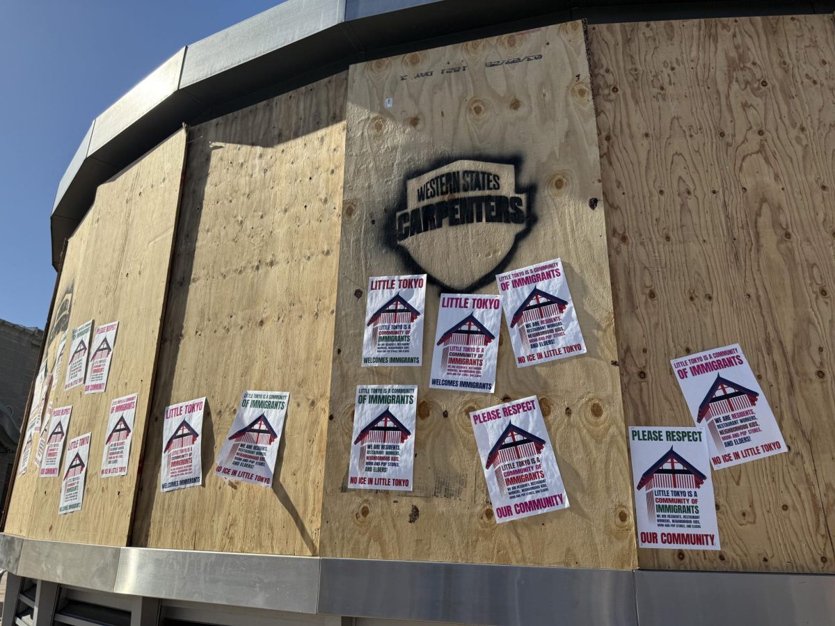 Flyers supporting the immigrant community in Little Tokyo are attached to the boarded-up walls of the Japanese American National Museum, which is currently closed for renovations (Jordan Pagkalinawan/ Beacon Staff).