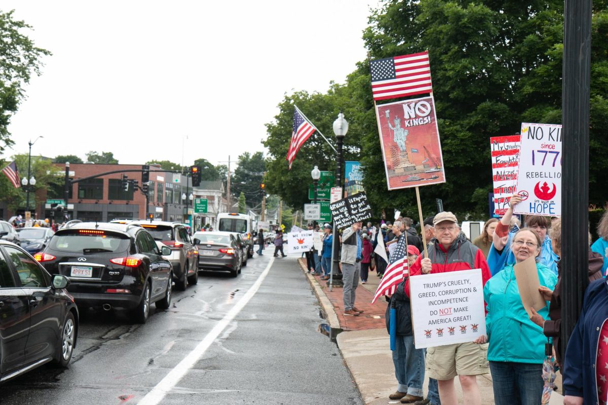 Protesters holding signs in Natick, MA for 'No Kings Day' protest on June 14, 2025 (Sam Shipman / Beacon Staff)