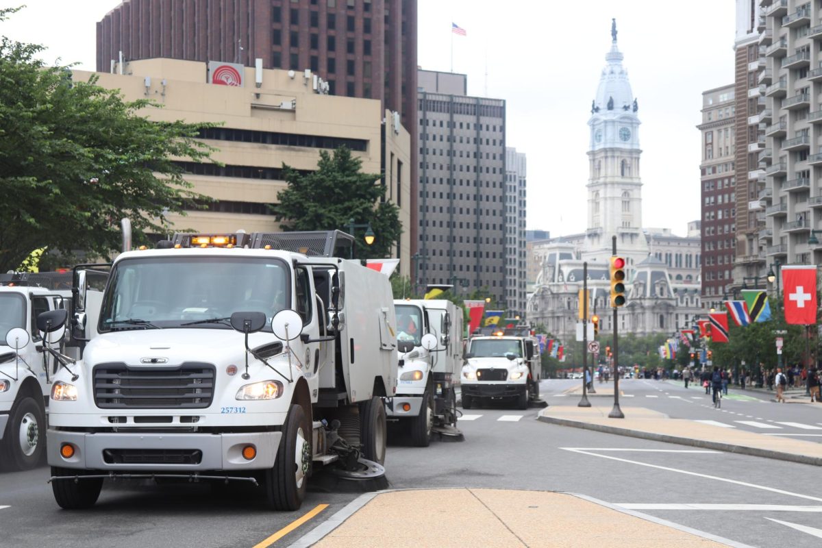 Dozens of street sweeper trucks enter Benjamin Franklin Parkway to clear debris left by "No Kings Day" protesters on June 14, 2025 (Bryan Hecht / Beacon Staff).