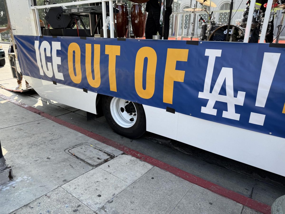 A truck carrying a local band bears the message "ICE out of LA" (Jordan Pagkalinawan/ Beacon Staff).