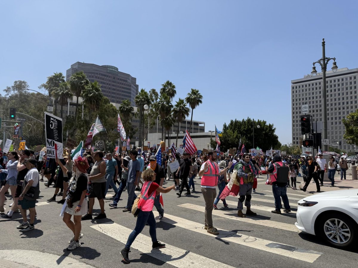 Volunteers block traffic as hundreds of demonstrators march along Main Street in Downtown Los Angeles (Jordan Pagkalinawan/ Beacon Staff).