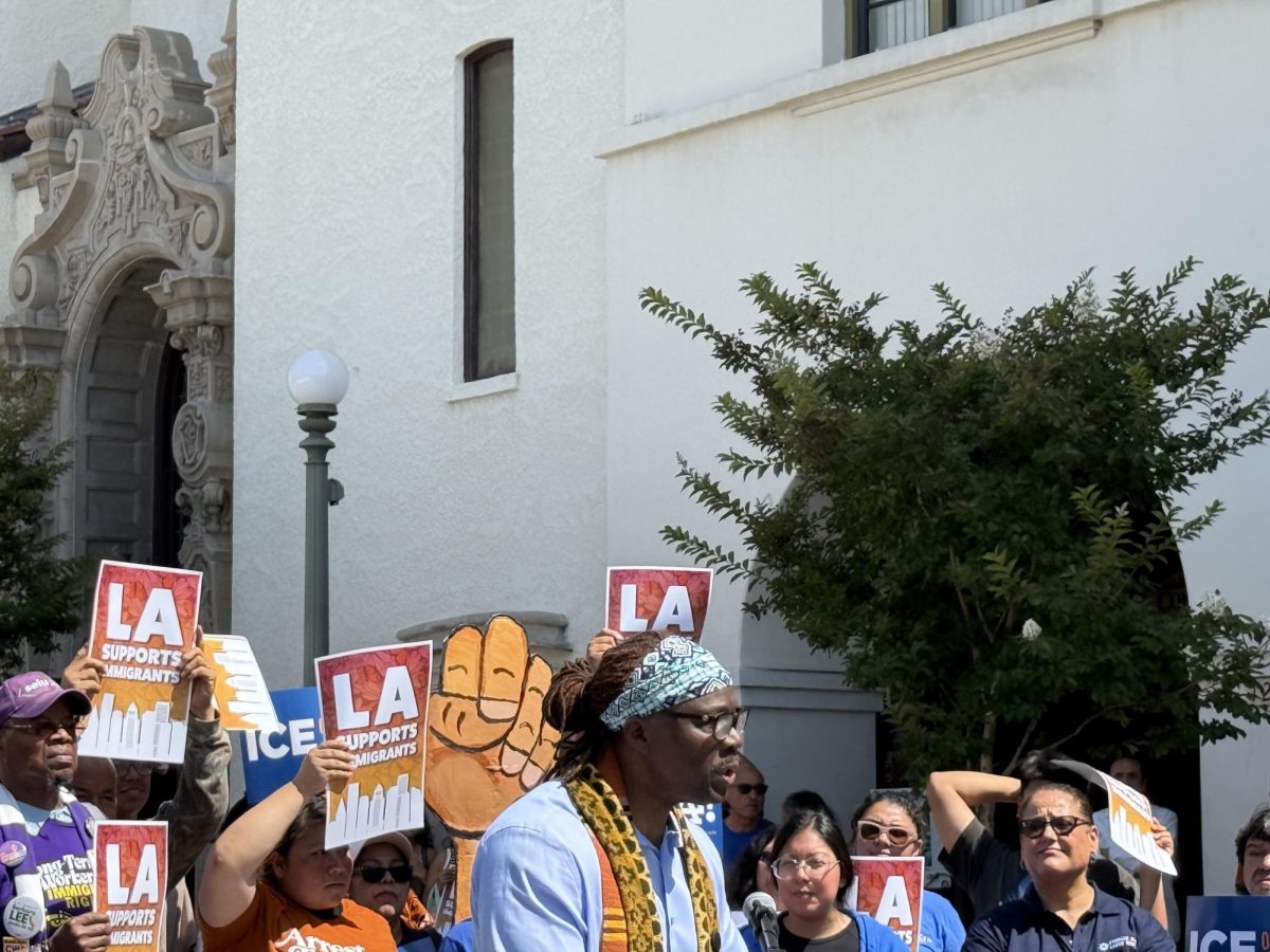 Pastor Stephen "Cue" Jn-Marie, founder of "The Row LA" (a "Church without Walls" on Skid Row), addresses the media and introduces speakers at a Summer of Resistance press conference on July 11, 2025 (Jordan Pagkalinawan/ Beacon Staff).