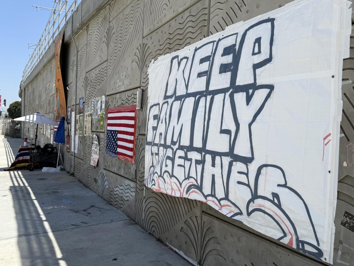 Anti-Trump and anti-ICE banners taped to a concrete wall across from the Metropolitan Detention Center on July 28, 2025 (Jordan Pagkalinawan/ Beacon Staff).