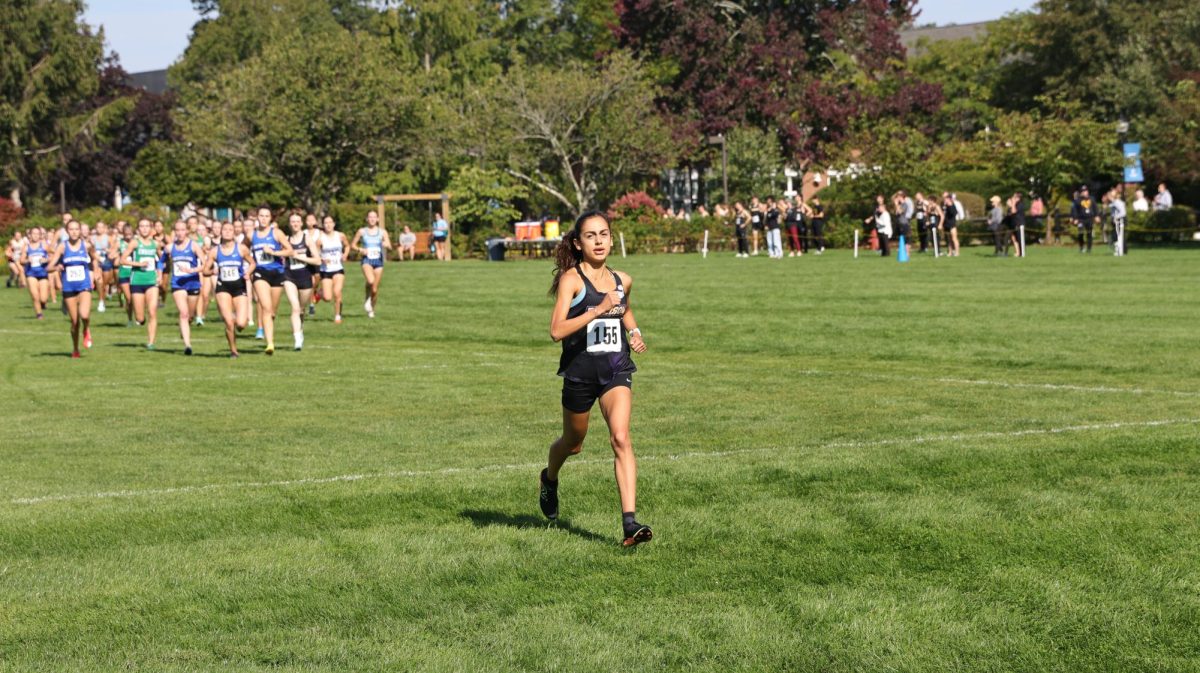 Emerson women's cross country runner Yasmin Defne Dadikhi leading the pack during the 52nd UMass Dartmouth XC Invitational. (Courtesy of Rob Rossi, Gordon College)