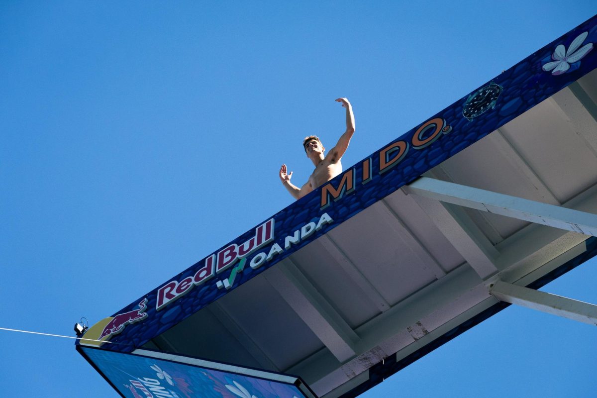 A cliff diver hypes up the crowd before leaping off the ICA (Bryce Heilmann/ For The Beacon).