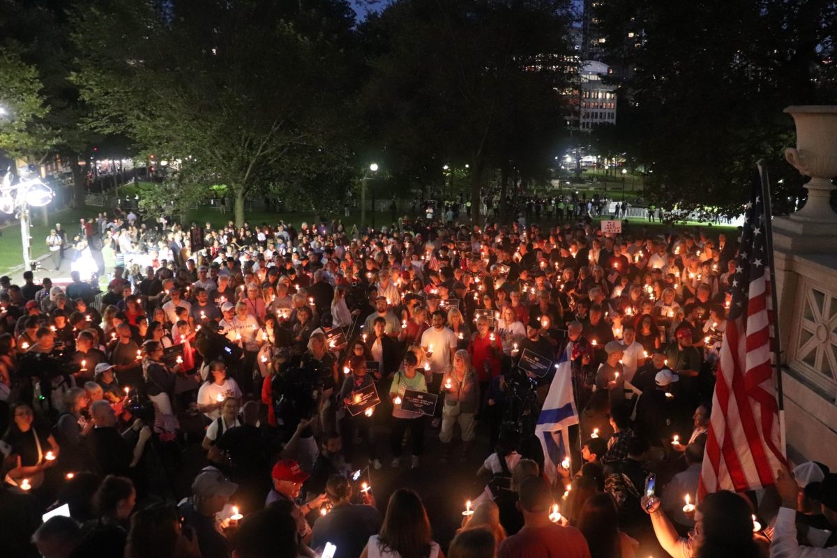 Thousands gathered beneath the Robert Gould Shaw & 54th Regiment Memorial near the Massachusetts State House for a vigil honoring assassinated conservative activist Charlie Kirk on Thursday, Sept. 18, 2025 (Bryan Hecht / Beacon Staff). 