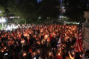 Thousands gathered beneath the Robert Gould Shaw & 54th Regiment Memorial near the Massachusetts State House for a vigil honoring assassinated conservative activist Charlie Kirk on Thursday, Sept. 18, 2025 (Bryan Hecht / Beacon Staff). 