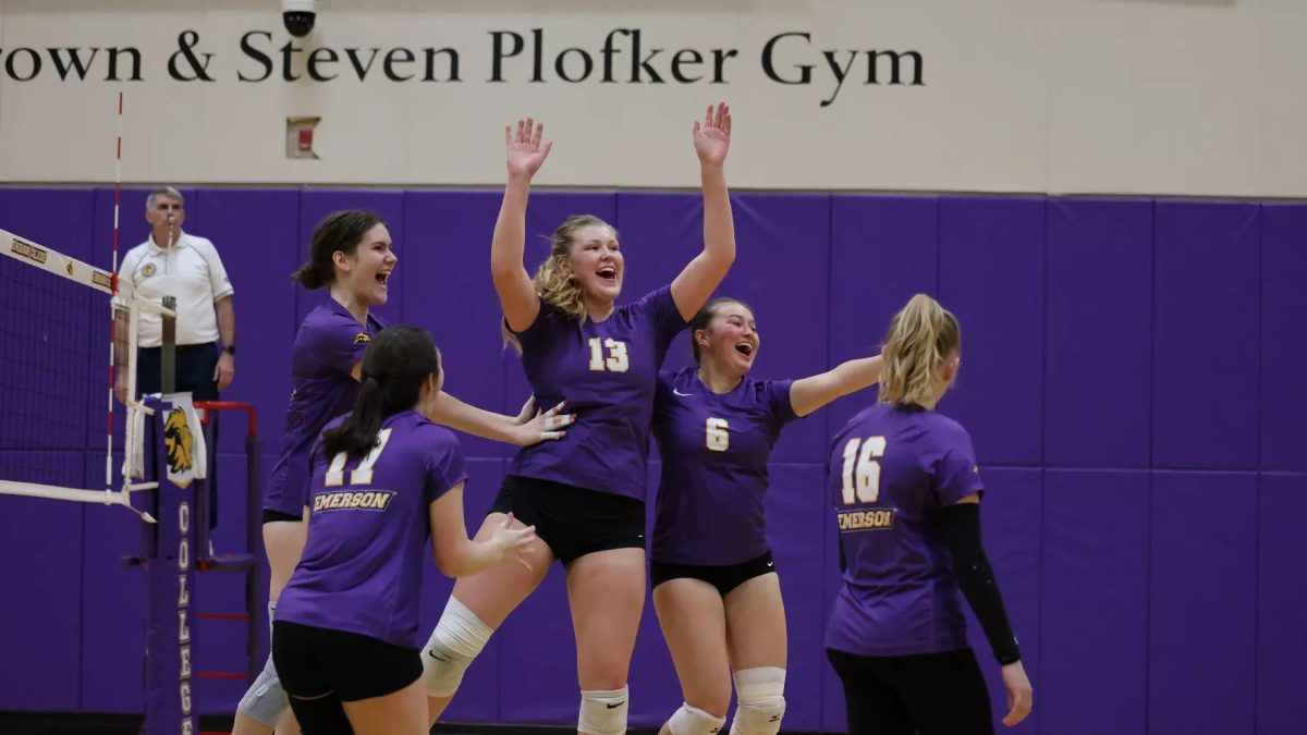 The Emerson women's volleyball team celebrates sophomore setter Chloe Hokenson after she reached 1,000 career assists (Courtesy of Doug Chin/DJC3 Sports & Entertainment).