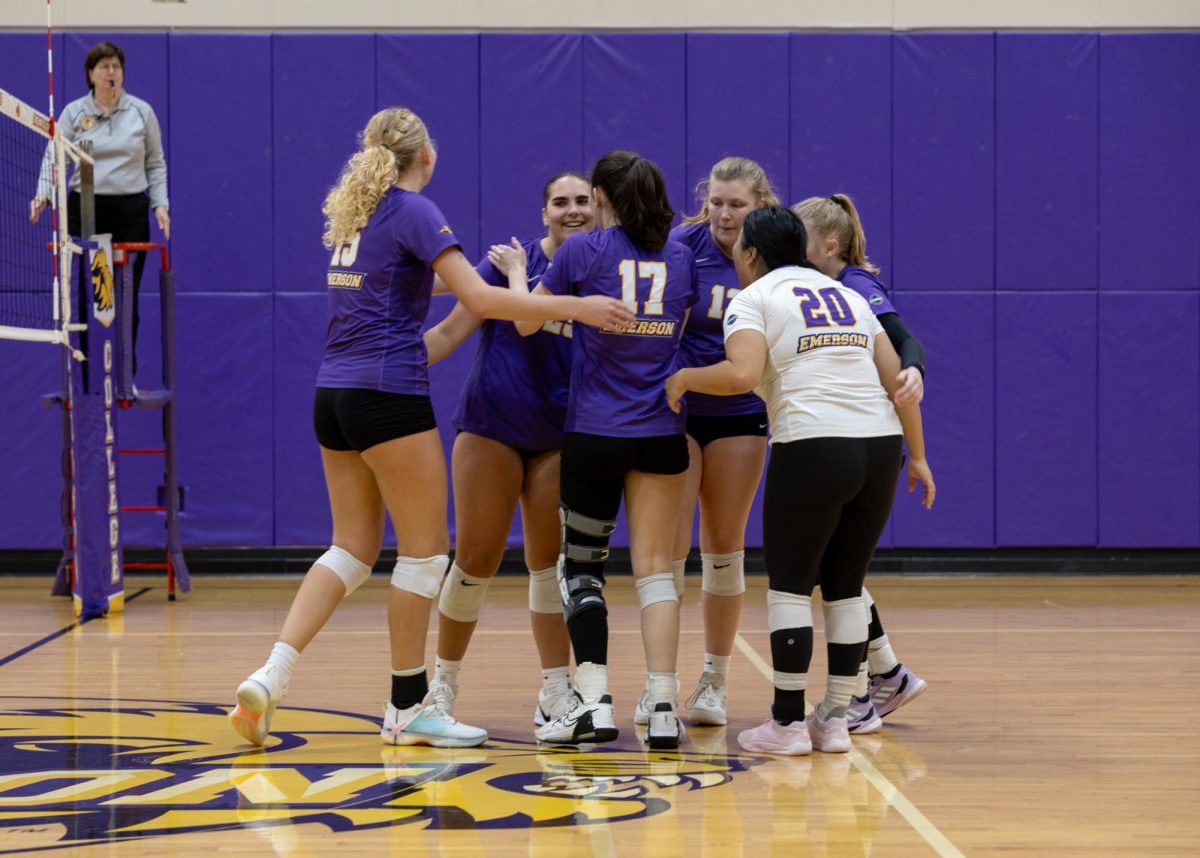 The Emerson women's volleyball team huddles against the Babson College Beavers on Oct. 7, 2025 (Jacob Goldberg/ For The Beacon).