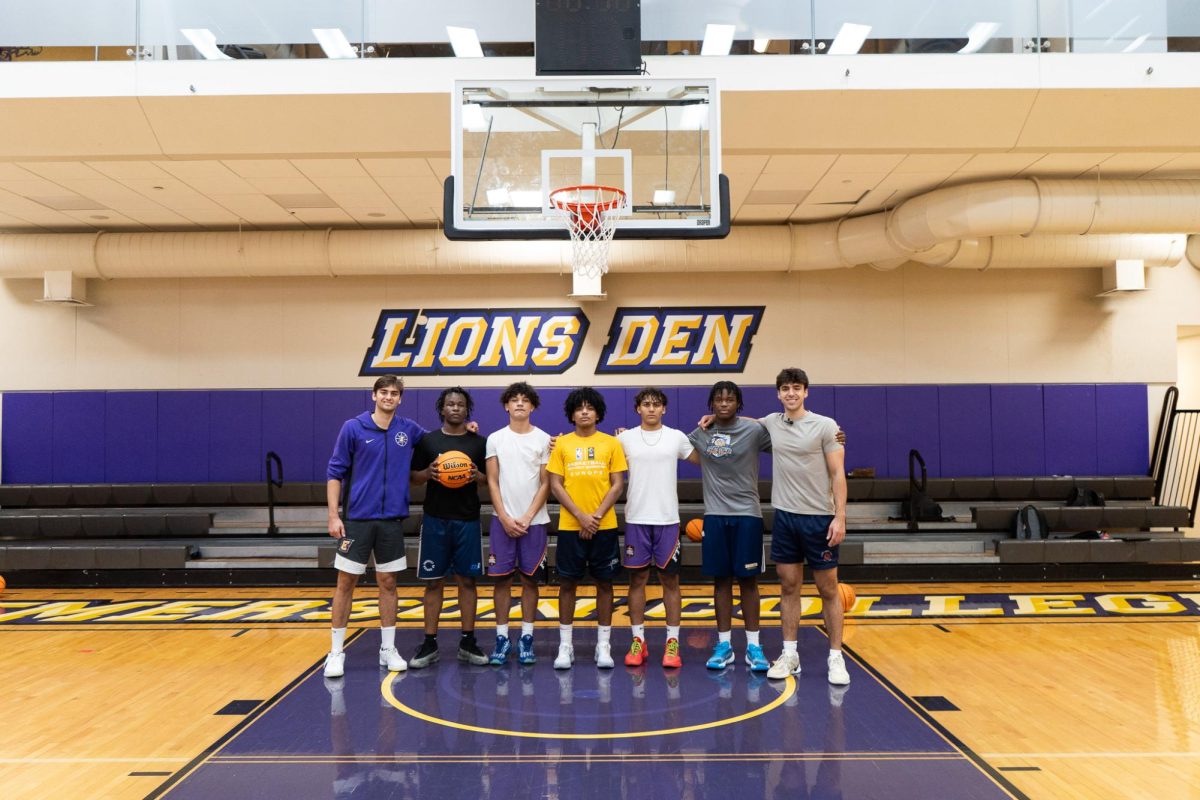 Men's basketball forwards Guillermo Gasset Ruiz (left) and Shay Roban (right) pose with mentees of the College Athlete Network (Courtesy of Guillermo Gasset Ruiz).